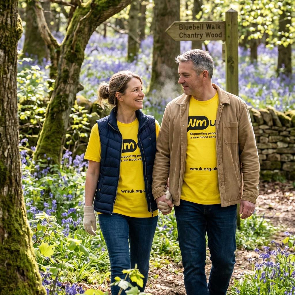 A man & woman wearing WMUK t-shirts while out on a walk in the country
